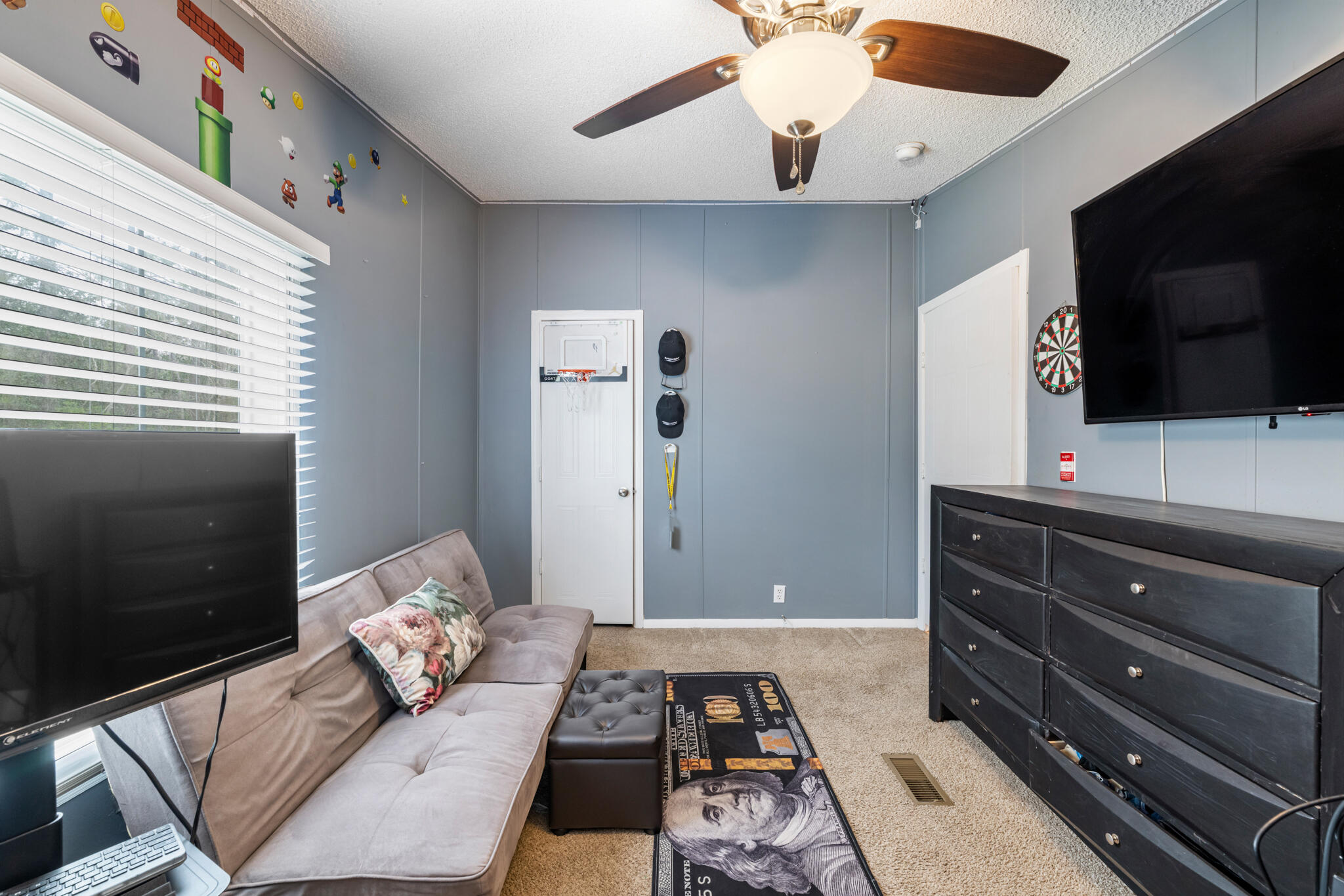 2422 Crescent Wood Road Navarre, FL 32566 - Photo 27 of 42 a bedroom with a bed and flat screen tv