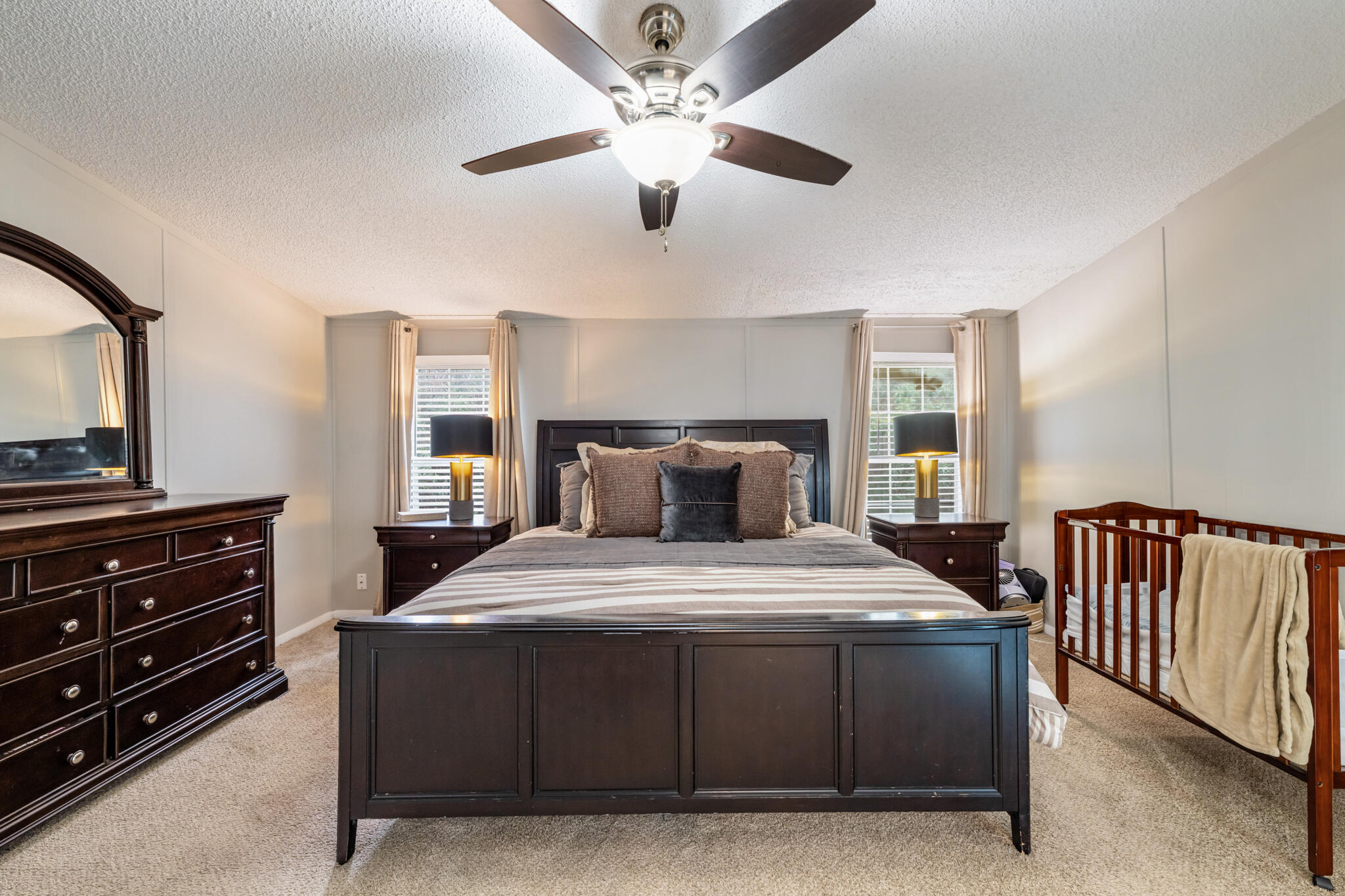 2422 Crescent Wood Road Navarre, FL 32566 - Photo 29 of 42 a bedroom with a bed and a chandelier