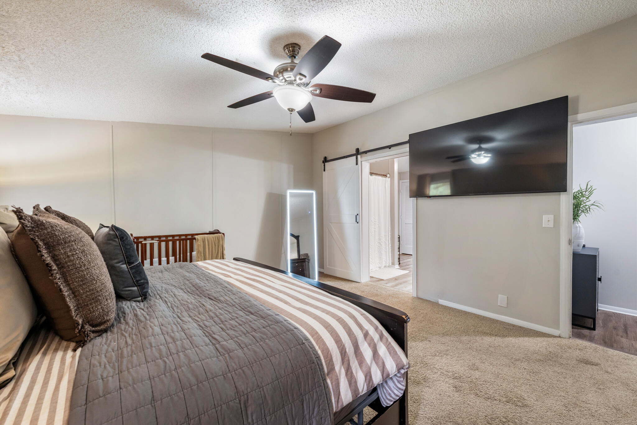 2422 Crescent Wood Road Navarre, FL 32566 - Photo 30 of 42 a bedroom with a bed and a flat screen tv