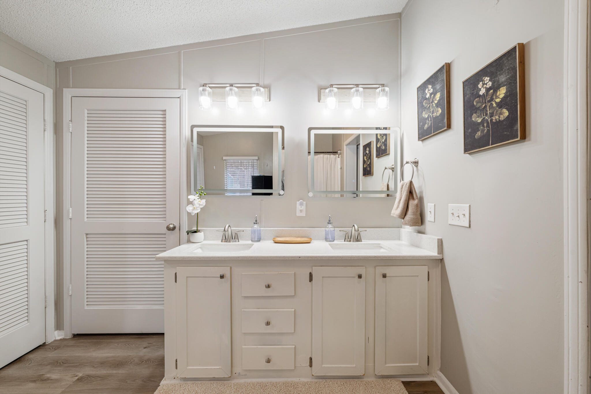 2422 Crescent Wood Road Navarre, FL 32566 - Photo 32 of 42 a bathroom with a double vanity sink a mirror and a