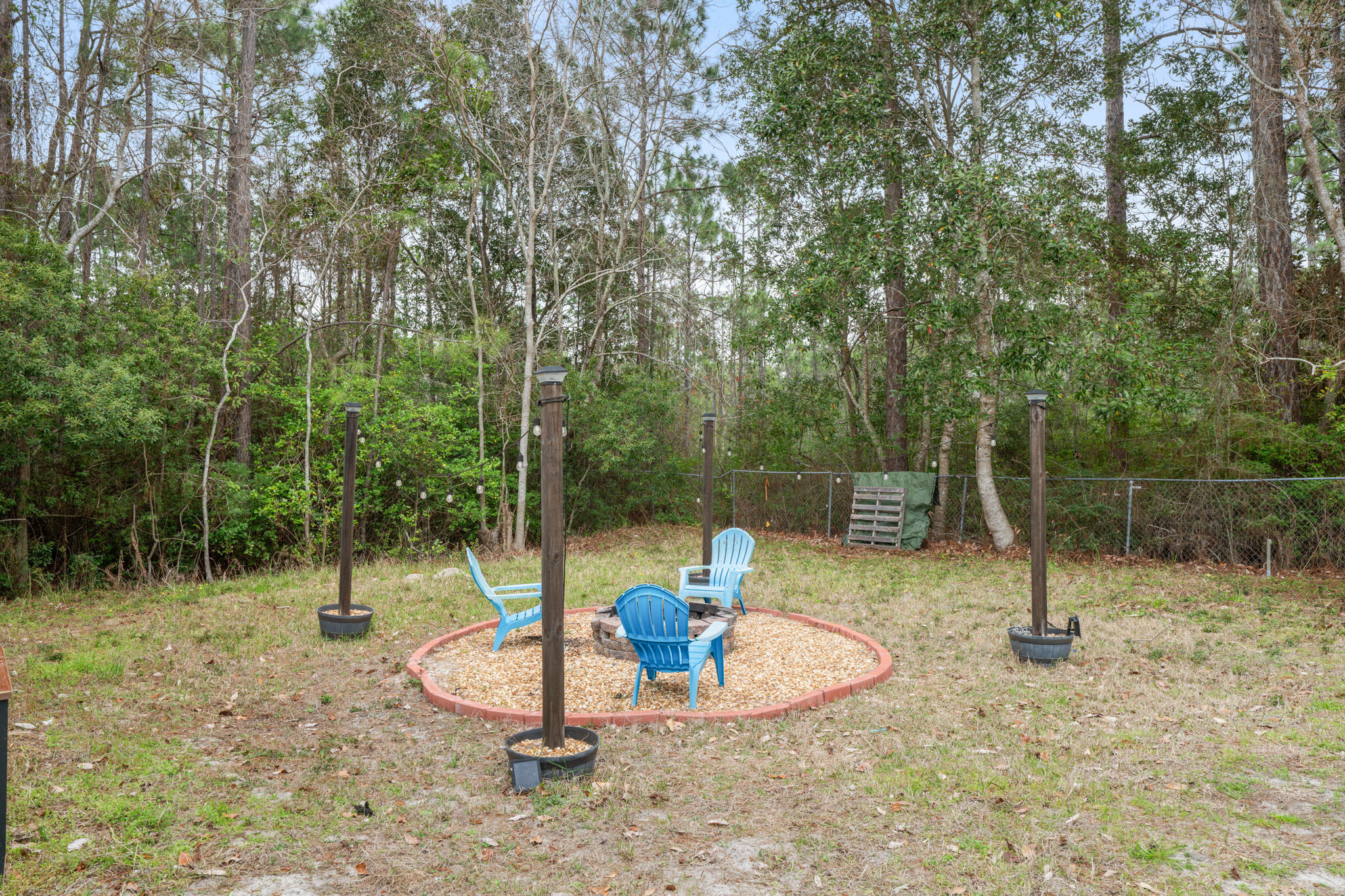 2422 Crescent Wood Road Navarre, FL 32566 - Photo 40 of 42 a backyard of a house with entertaining space and trampoline