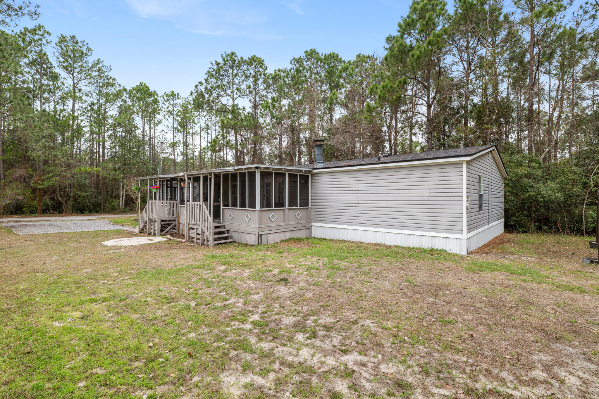 2422 Crescent Wood Road Navarre, FL 32566 - Photo 5 of 42 a view of a house with backyard and trees