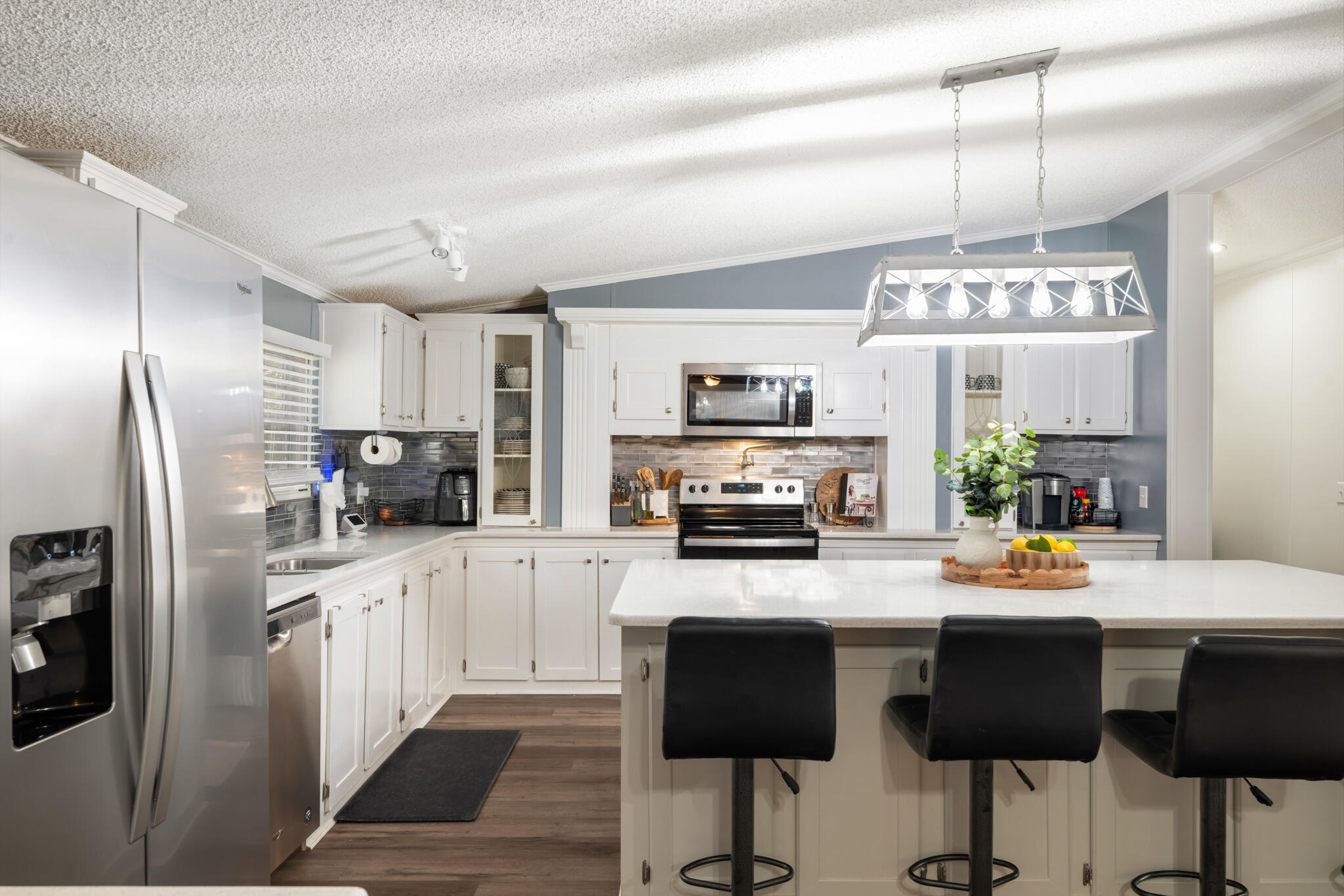 2422 Crescent Wood Road Navarre, FL 32566 - Photo 10 of 42 a kitchen with stainless steel appliances a stove refrigerator sink and microwave