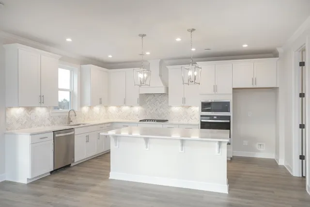 a large kitchen with stainless steel appliances granite countertop a large center island and a sink