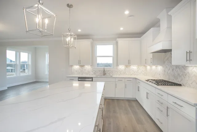 a kitchen with granite countertop a sink stove and cabinets