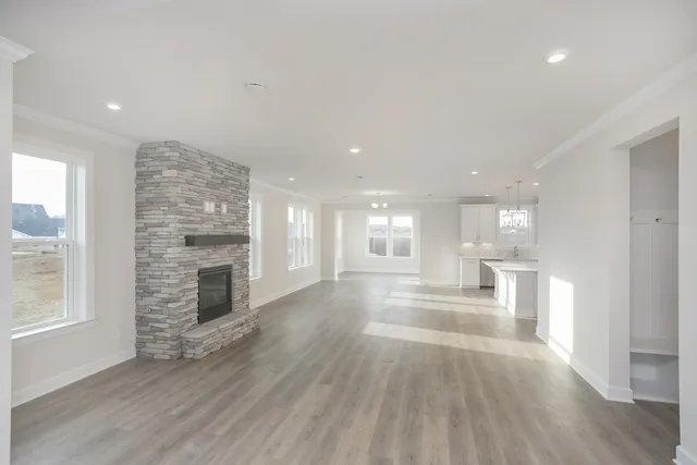 a view of empty room with wooden floor and fireplace