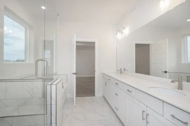 a bathroom with a double vanity sink and a mirror