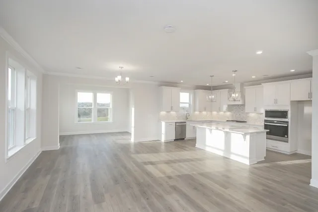 a view of kitchen with wooden floor and windows