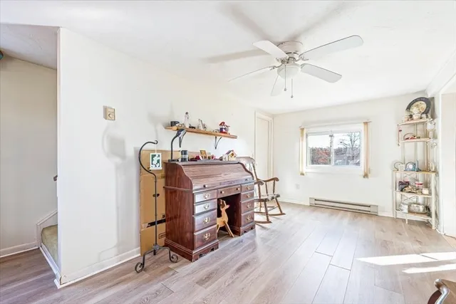 a view of a workspace with furniture and a window