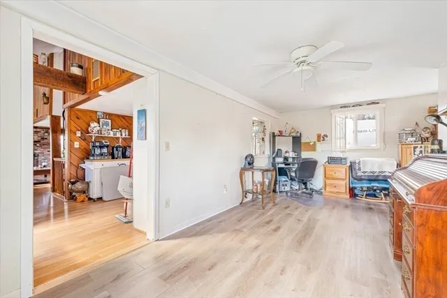 a living room filled with furniture and a wooden floor