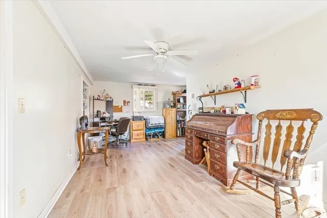 a living room with furniture a fireplace and wooden floor