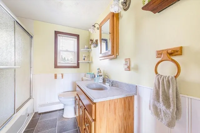 a bathroom with a sink a toilet and mirror