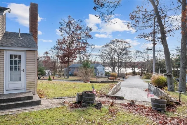 a view of a backyard with table and chairs