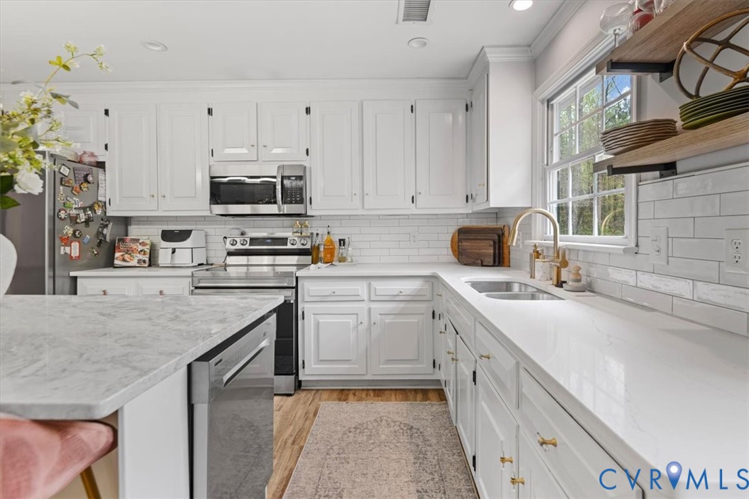 9820 Beaver Bridge Road Chesterfield, VA 23838 - Photo 16 of 54 Bright kitchen featuring white cabinetry, subway t