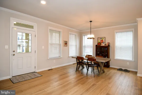 a dining room with furniture and wooden floor