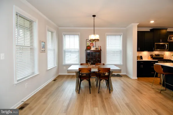 a view of a dining room with furniture window and wooden floor