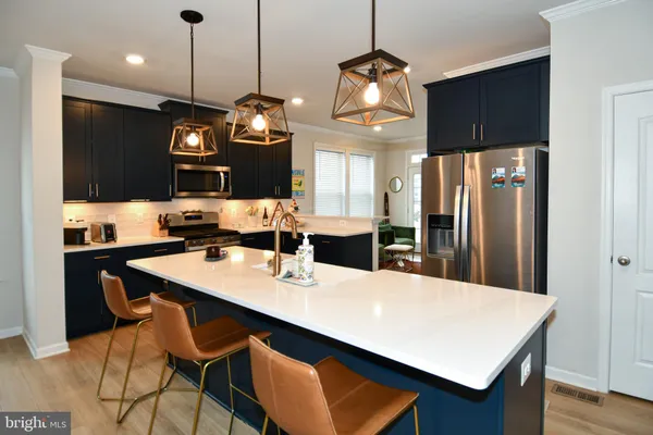a large kitchen with a table and chairs
