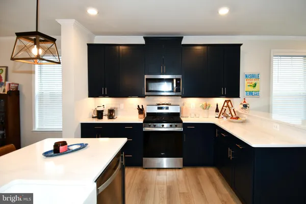 a kitchen with a sink a stove and microwave