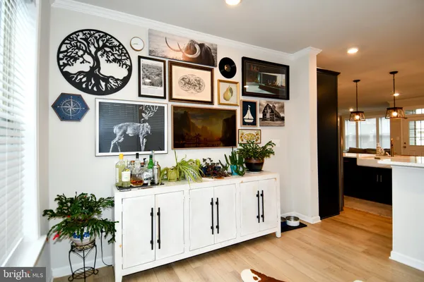 a view of a kitchen area with furniture and wooden floor