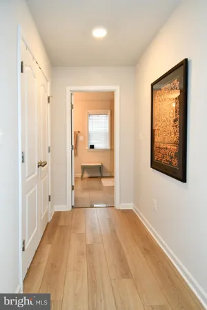 a view of a room with wooden floor and a bathroom