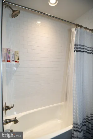 a bathroom with a shower and a bath tub