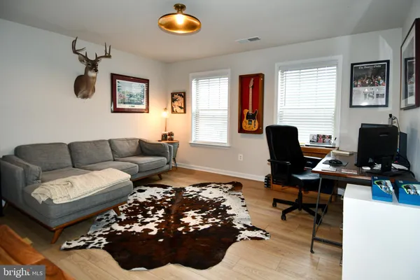 a living room with furniture rug and a window