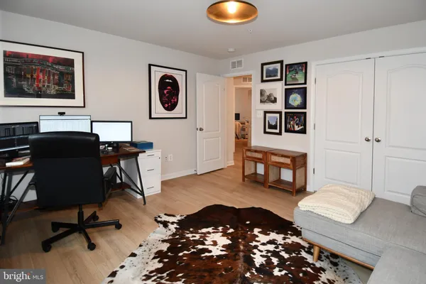 a view of a livingroom with workspace and a couch