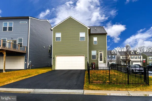 a front view of a house with outdoor seating