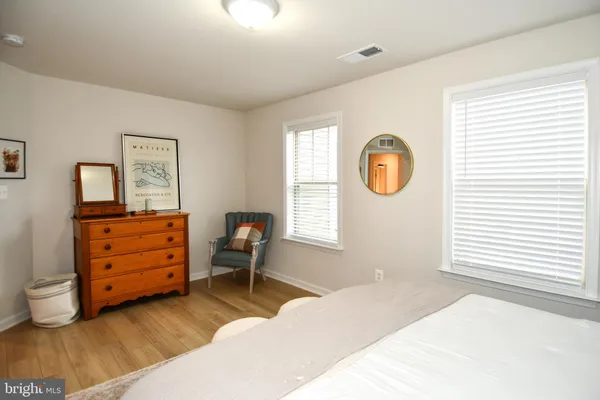 a bedroom with a bed and a dresser