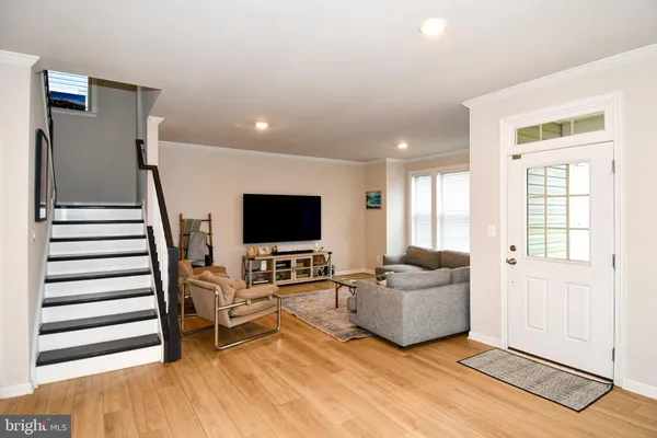 a dining room with furniture and wooden floor