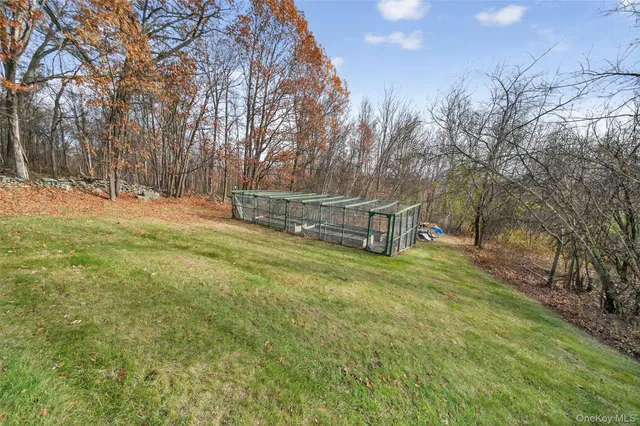 a view of a playground with a bench and trees