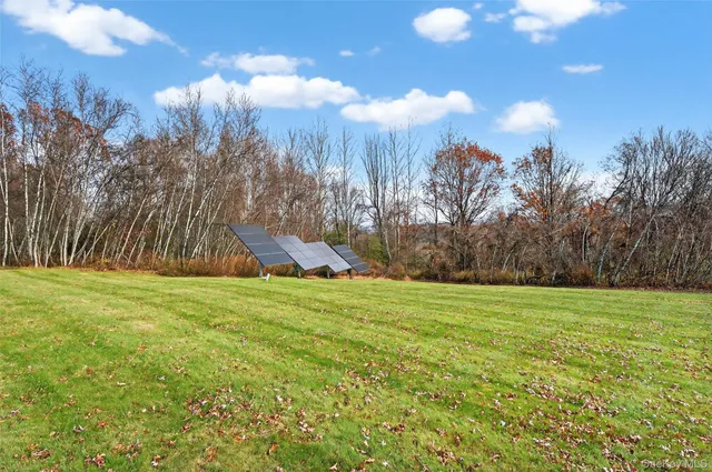 a view of a big yard with an outdoor space and seating area