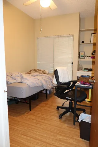 a bedroom with a bed and a desk