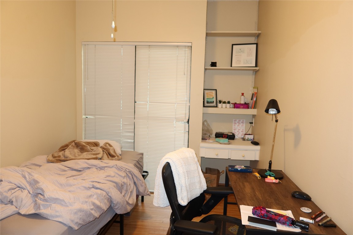 612 Park Place, Unit 202 Austin, TX 78705 - Photo 21 of 25 a bedroom with a bed and a chair