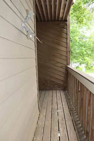 a view of a balcony with wooden floor