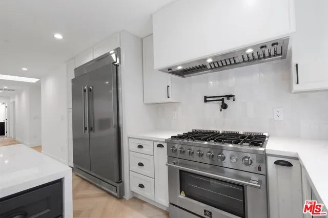 a kitchen with a stove and a refrigerator