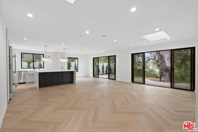 a view of an empty room with a sliding door and mountain view