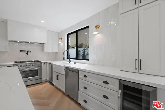 a kitchen with stainless steel appliances granite countertop a stove and a sink