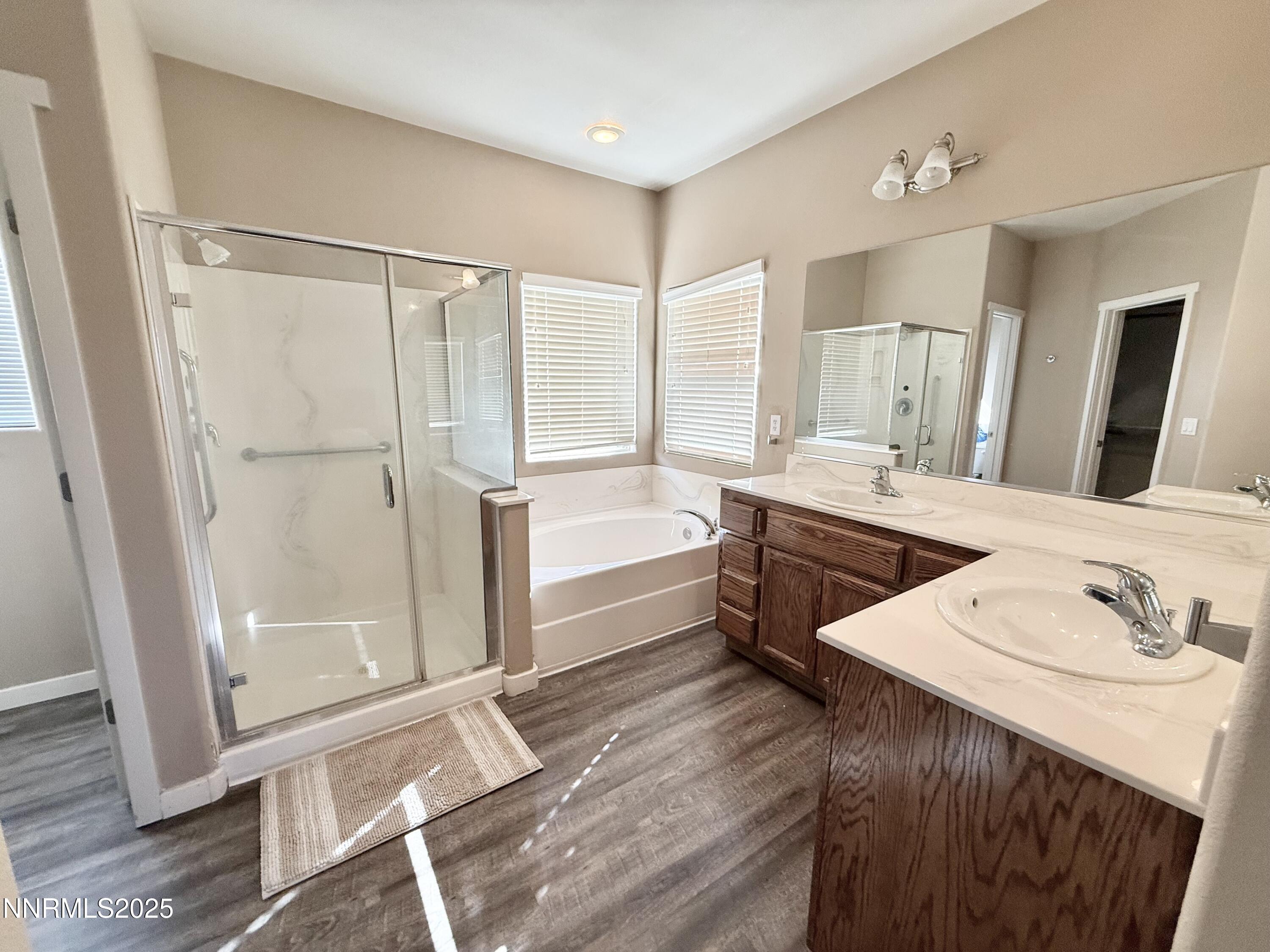 955 Aster Lane Fernley, NV 89408 - Photo 11 of 14 a spacious bathroom with a double vanity sink a mirror and a bathtub