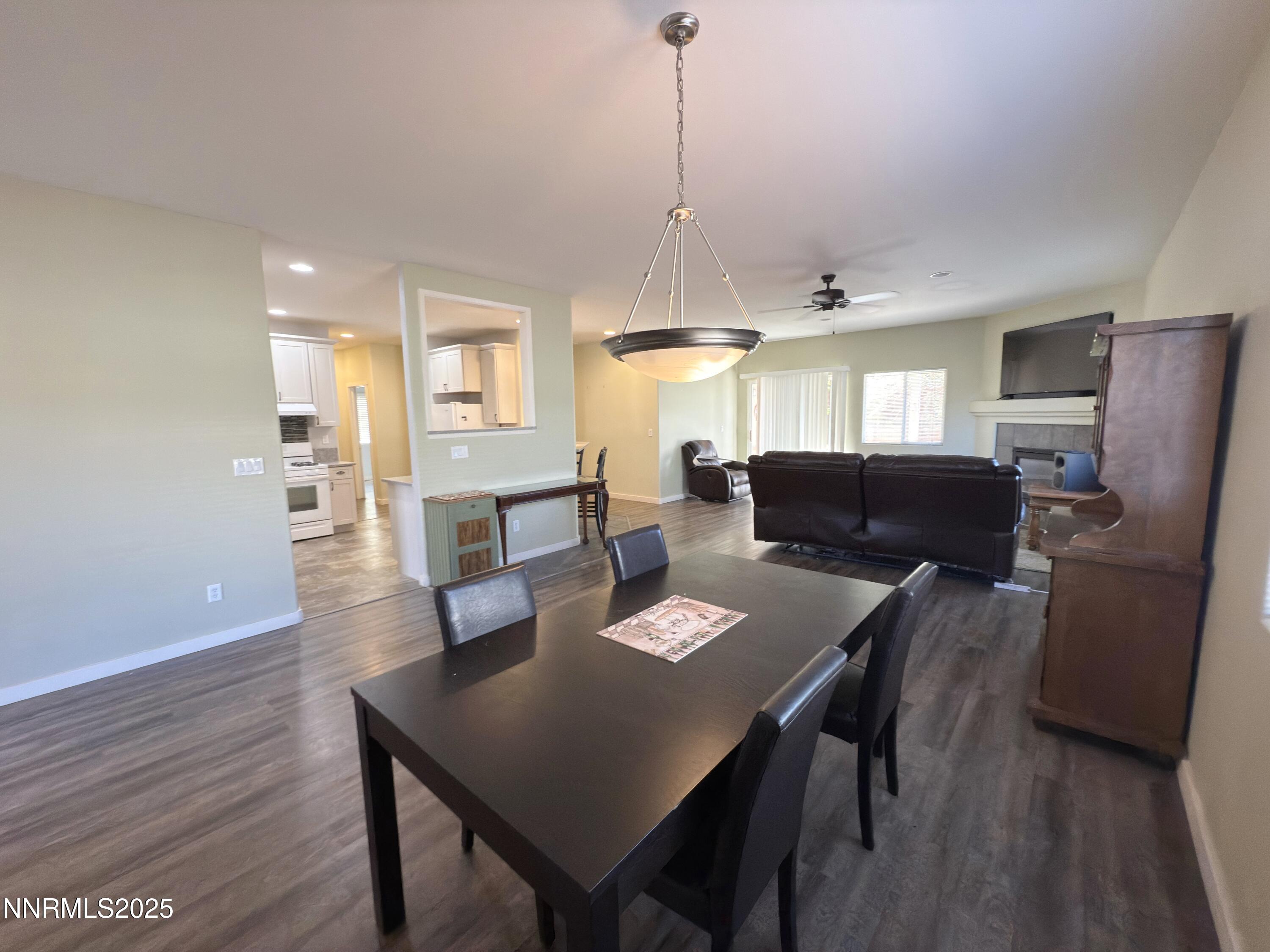 955 Aster Lane Fernley, NV 89408 - Photo 3 of 14 a view of a dining room with furniture and wooden floor