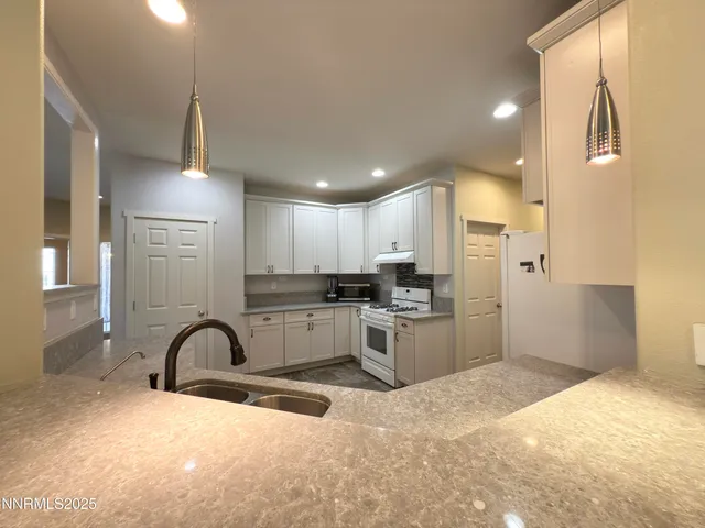 a kitchen with stainless steel appliances kitchen island a refrigerator sink cabinets and microwave