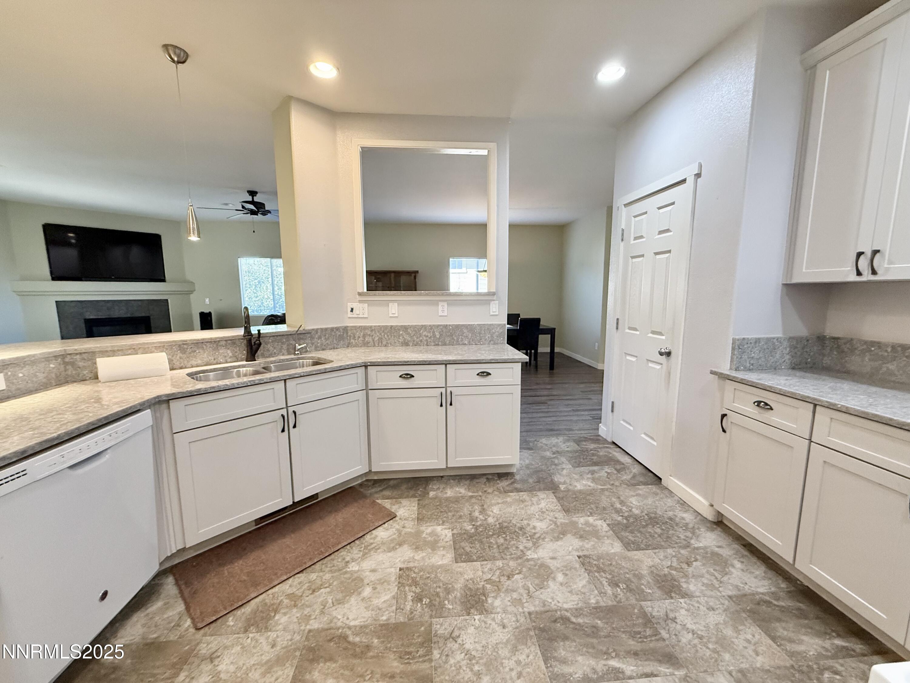 955 Aster Lane Fernley, NV 89408 - Photo 6 of 14 a large white kitchen with a sink and cabinets