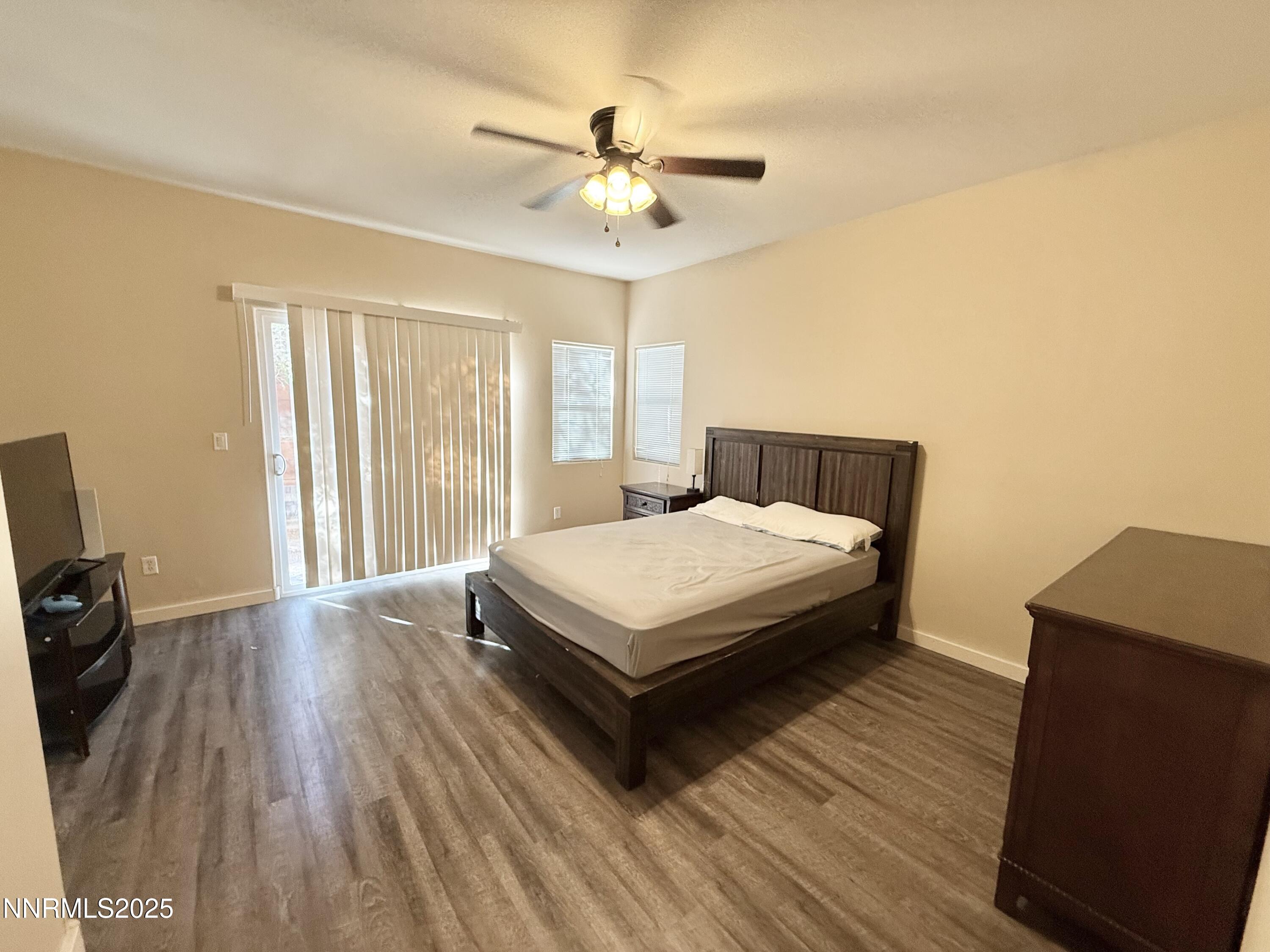 955 Aster Lane Fernley, NV 89408 - Photo 9 of 14 a bedroom with a bed and wooden floor