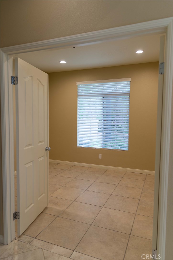 8215 East White Oak Ridge, Unit 108 Orange, CA 92869 - Photo 7 of 15 Downstairs bedroom with double doors, recessed lighting and mirrored closet doors
