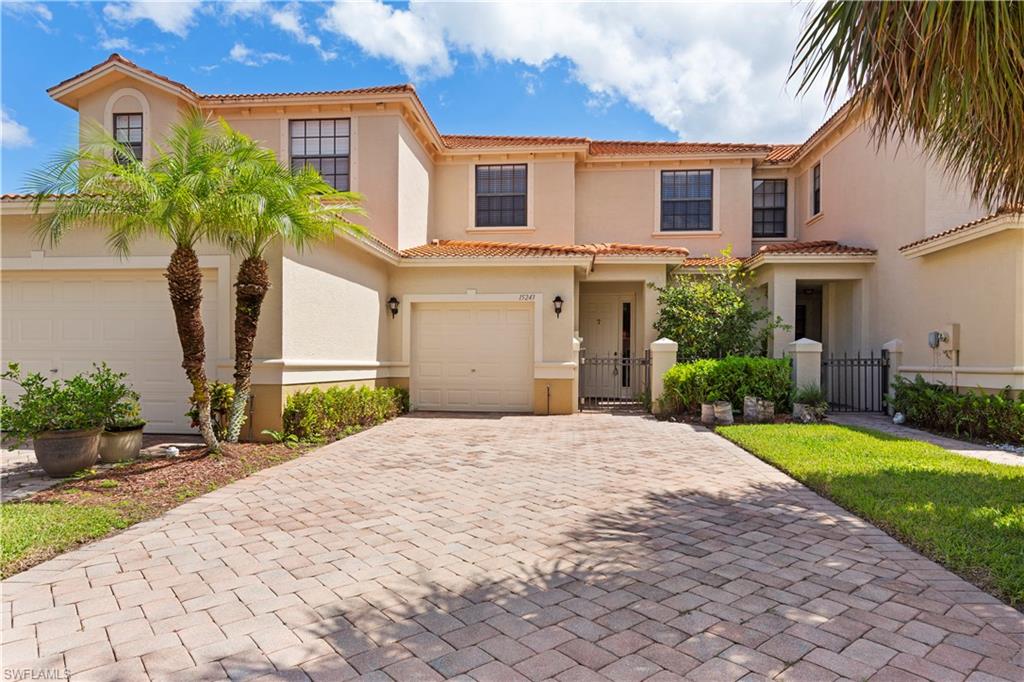 15243 Summit Pl Circle, Unit 247 Naples, FL 34119 - Photo 1 of 19 a front view of a house with a garden