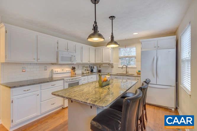 13 East Point Road Palmyra, VA 22963 - Photo 12 of 47 a kitchen with stainless steel appliances granite countertop a sink a refrigerator and white cabinets