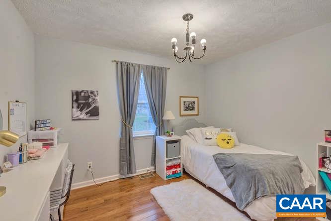 13 East Point Road Palmyra, VA 22963 - Photo 19 of 47 a bedroom with a bed and wooden floor