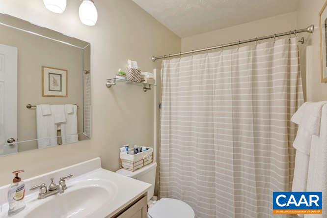13 East Point Road Palmyra, VA 22963 - Photo 21 of 47 a bathroom with a sink a toilet and shower curtain