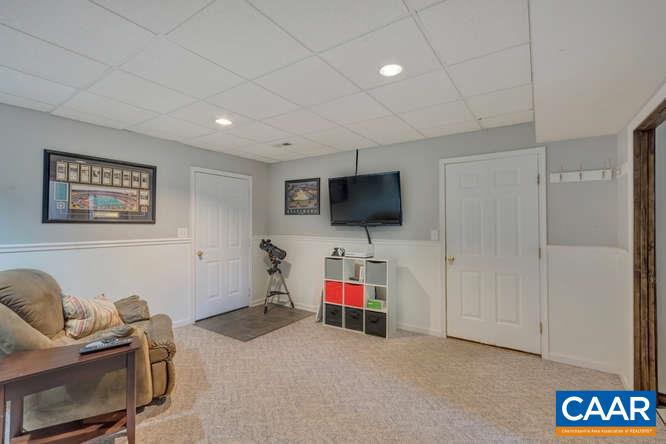 13 East Point Road Palmyra, VA 22963 - Photo 24 of 47 a living room with furniture and a flat screen tv