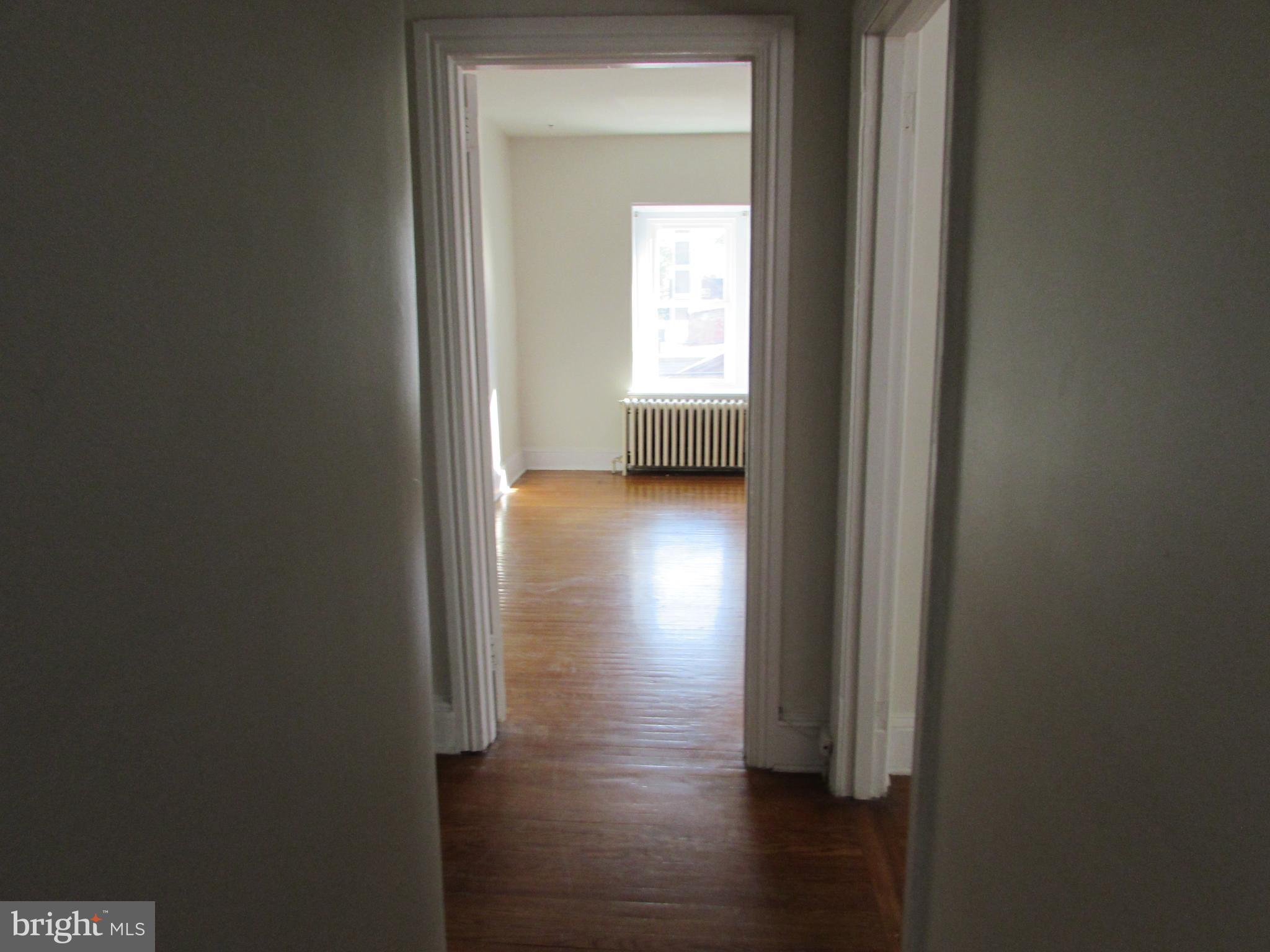 5903 Greene Street, Unit 3 Philadelphia, PA 19144 - Photo 15 of 19 a view of a hallway with wooden floor and a bathroom